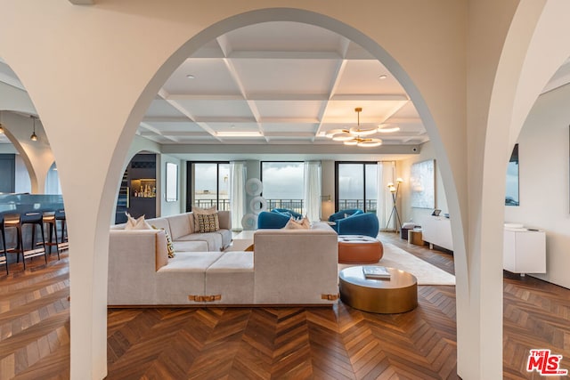 living room featuring parquet floors, coffered ceiling, and beamed ceiling