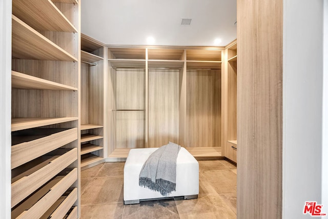 spacious closet with light tile patterned flooring