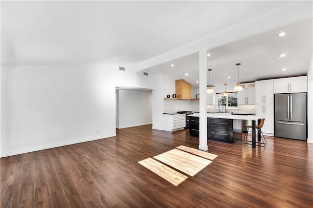 unfurnished living room featuring vaulted ceiling with beams and dark wood-type flooring