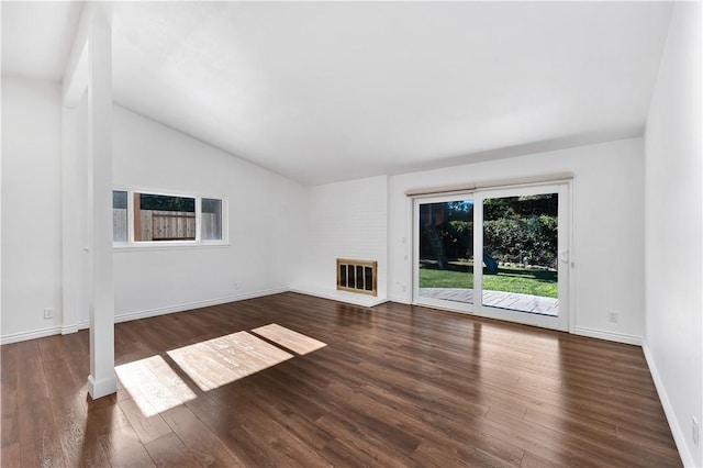 unfurnished living room featuring a fireplace, dark hardwood / wood-style floors, and lofted ceiling