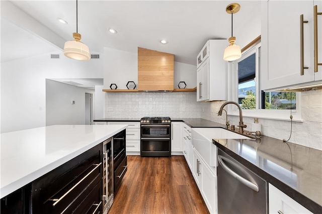 kitchen with white cabinets, double oven range, hanging light fixtures, and stainless steel dishwasher