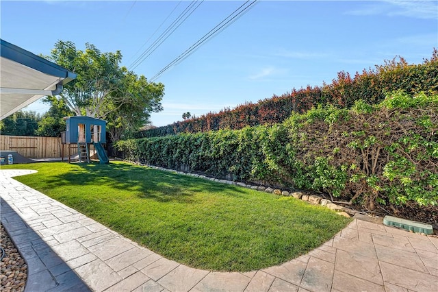 view of yard with a playground, a patio, and a shed