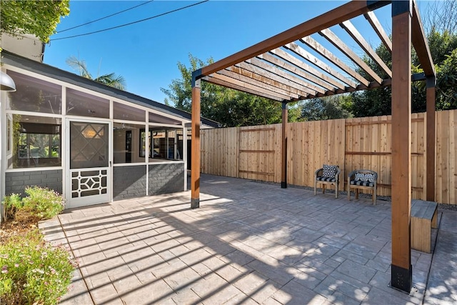 view of patio / terrace with a pergola and a sunroom