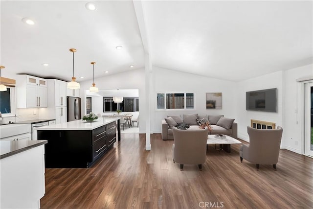 living room featuring lofted ceiling with beams and dark hardwood / wood-style flooring