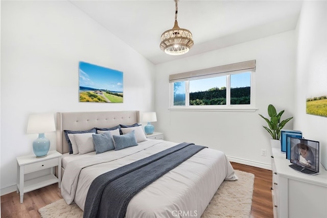 bedroom featuring hardwood / wood-style flooring and vaulted ceiling