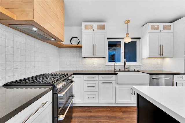 kitchen with white cabinets, hanging light fixtures, range with two ovens, and tasteful backsplash