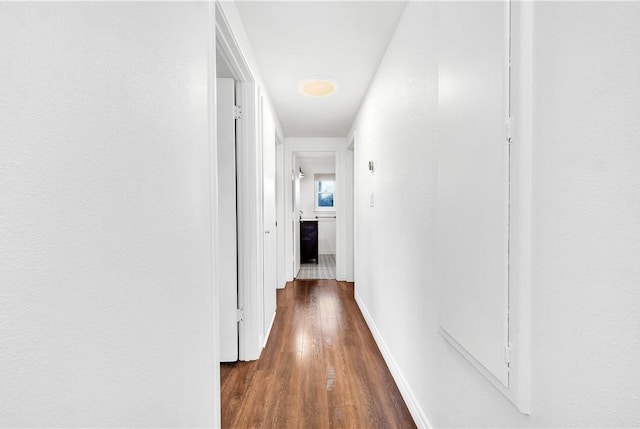 hall with dark hardwood / wood-style flooring