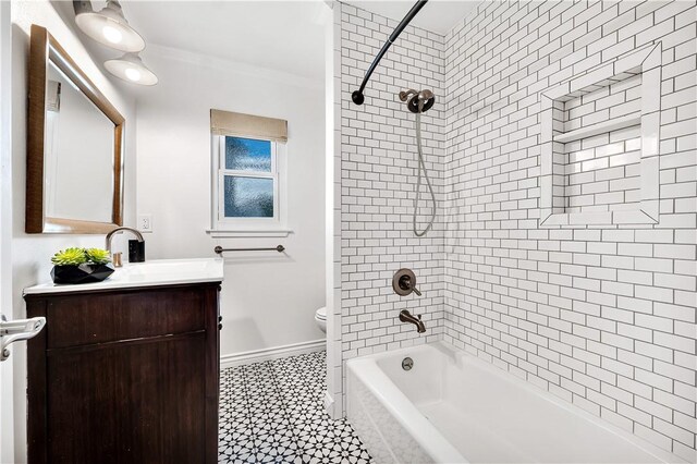 full bathroom featuring toilet, tiled shower / bath, vanity, and ornamental molding