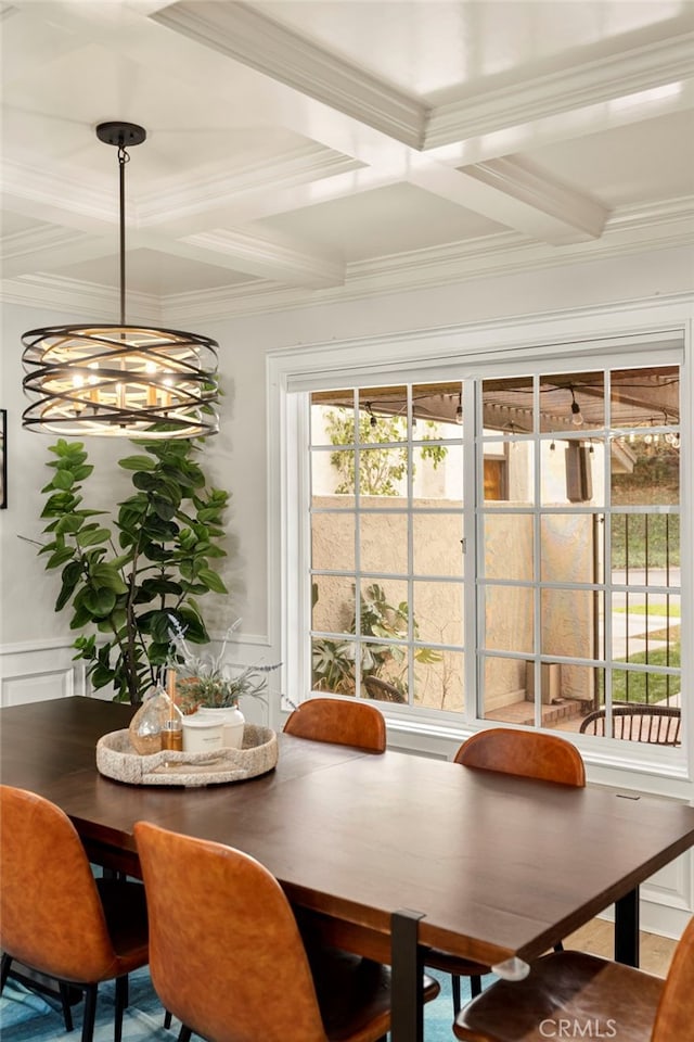 dining area with beam ceiling, an inviting chandelier, coffered ceiling, and ornamental molding