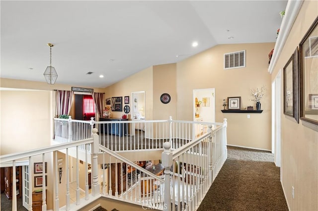 hall with lofted ceiling and carpet