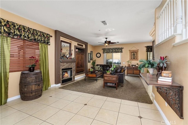 living room featuring light tile patterned floors and ceiling fan