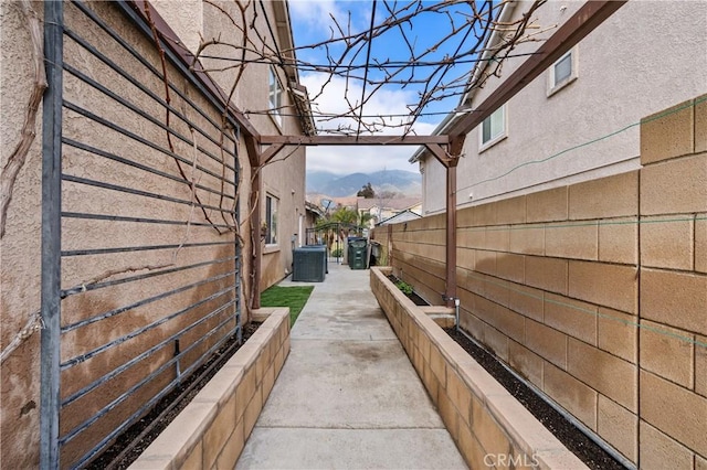 view of home's exterior featuring a mountain view and central air condition unit