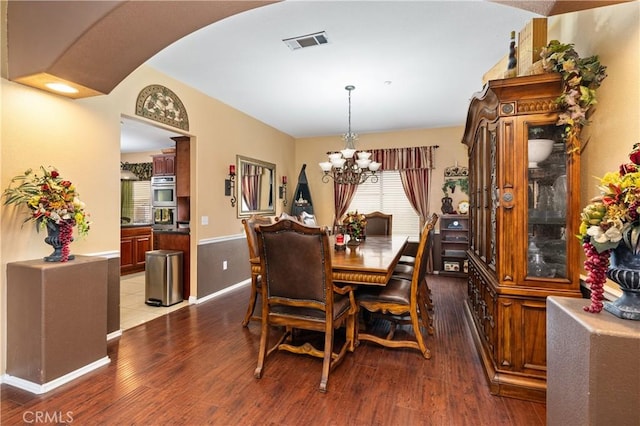 dining space featuring a chandelier and hardwood / wood-style floors