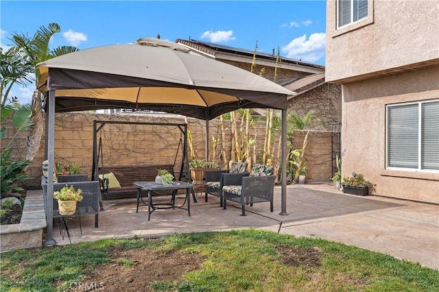 view of patio featuring an outdoor living space and a gazebo