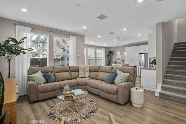 living room featuring light hardwood / wood-style flooring and a healthy amount of sunlight