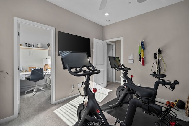 exercise area with ceiling fan and light colored carpet