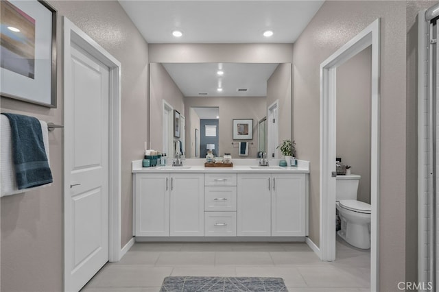 bathroom featuring toilet, tile patterned flooring, and vanity