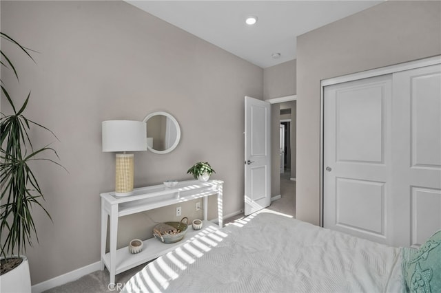 bedroom with a closet and light colored carpet