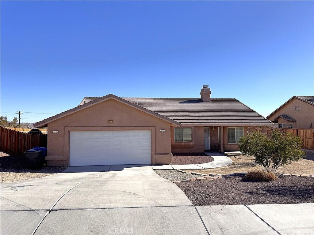 ranch-style home featuring a garage