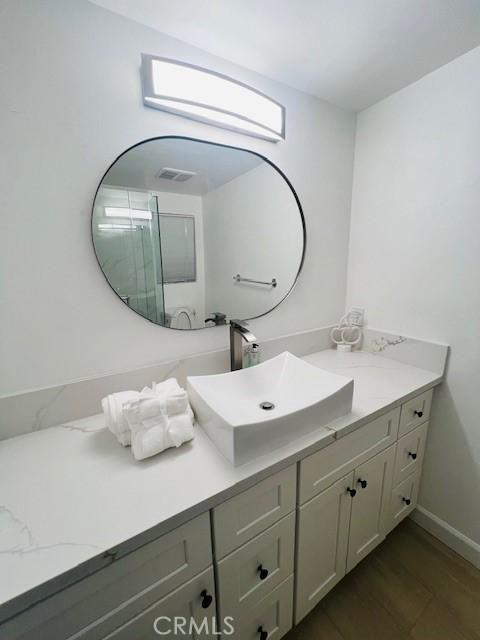 bathroom featuring vanity and hardwood / wood-style floors