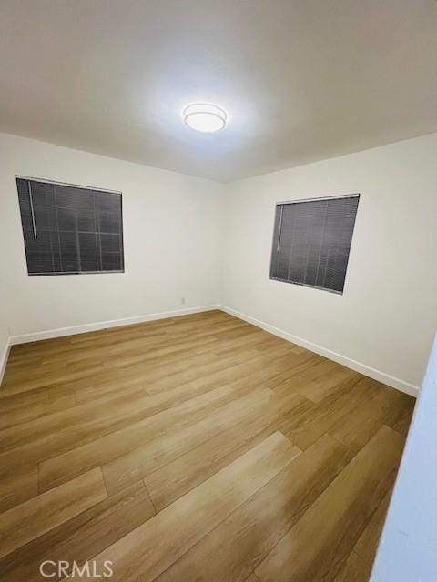 unfurnished room with hardwood / wood-style flooring