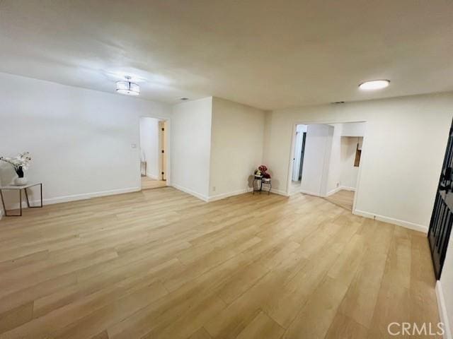 empty room with light hardwood / wood-style flooring