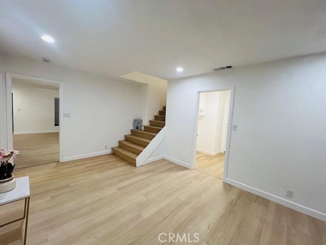 basement with light hardwood / wood-style flooring