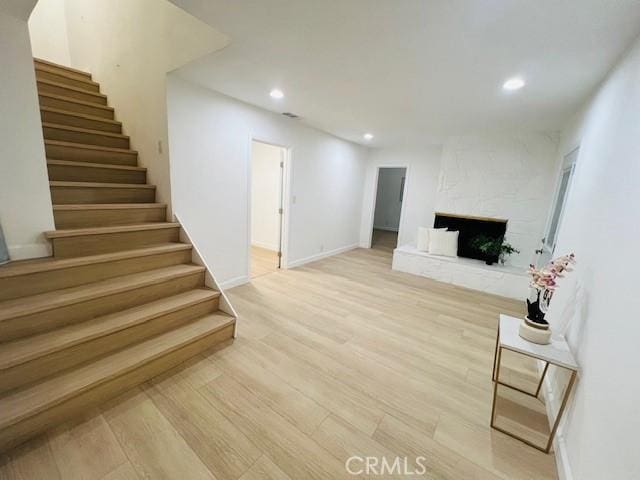 living room with a fireplace and light hardwood / wood-style floors