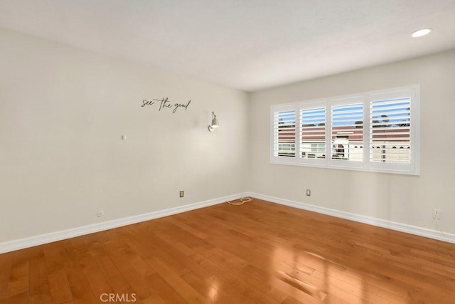 spare room with hardwood / wood-style flooring