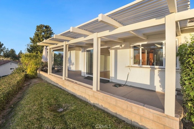 back of property with a pergola and a patio