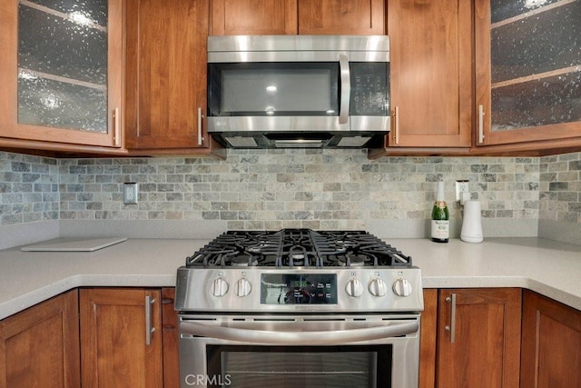 kitchen with decorative backsplash and appliances with stainless steel finishes