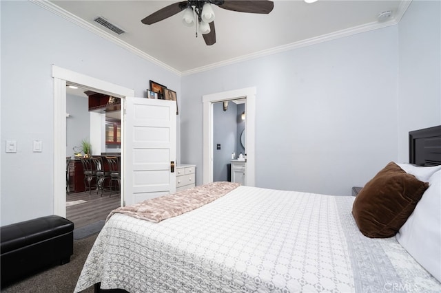 bedroom with ceiling fan, ensuite bath, and ornamental molding