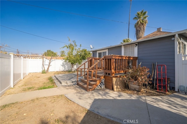 view of yard with a deck and a patio