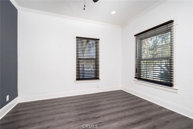 empty room with dark wood-type flooring, crown molding, and a healthy amount of sunlight