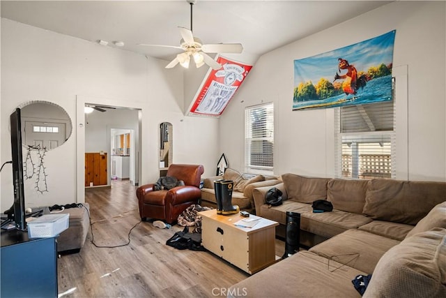 living room featuring vaulted ceiling, ceiling fan, and light hardwood / wood-style flooring