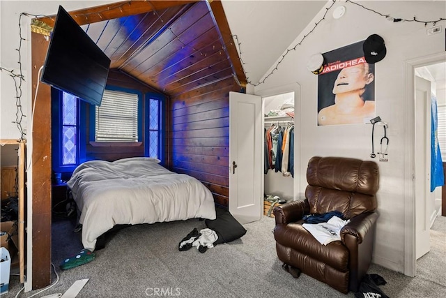 carpeted bedroom featuring a closet, lofted ceiling, wood walls, and wooden ceiling