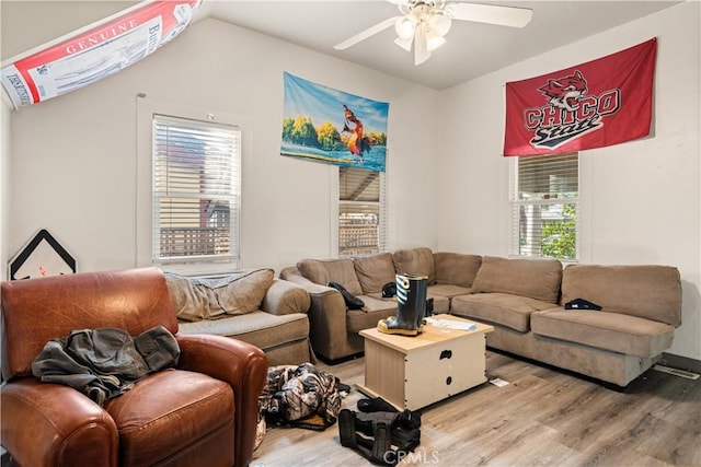 living room featuring ceiling fan, vaulted ceiling, and light hardwood / wood-style floors