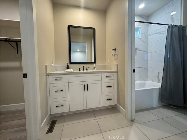 bathroom with shower / bath combination with curtain, tile patterned floors, and vanity