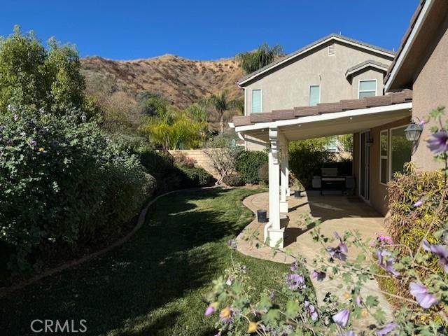 view of yard with a mountain view and a patio