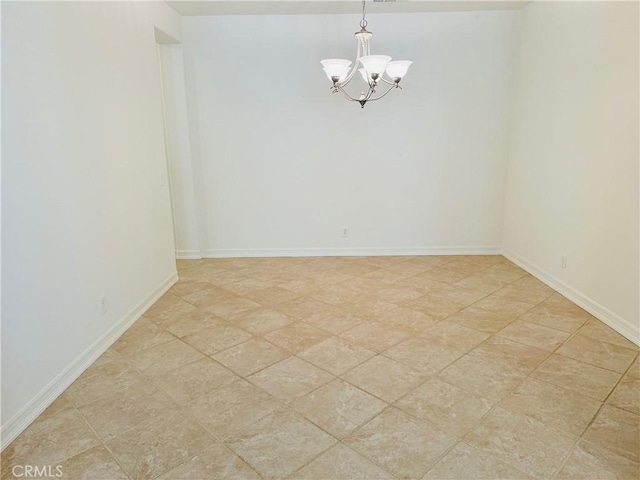 empty room featuring an inviting chandelier