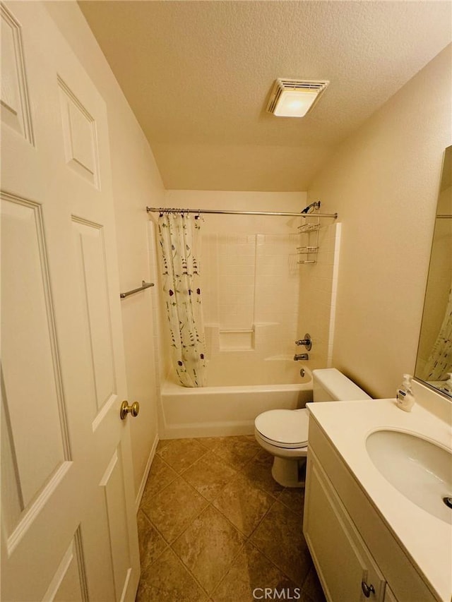 full bathroom featuring vanity, shower / tub combo with curtain, a textured ceiling, and toilet