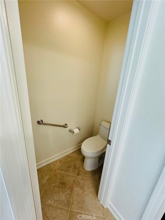 bathroom with tile patterned flooring and toilet