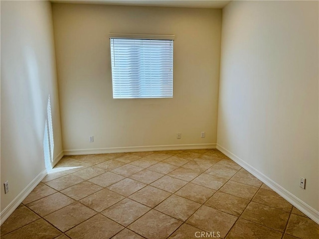 spare room featuring light tile patterned flooring