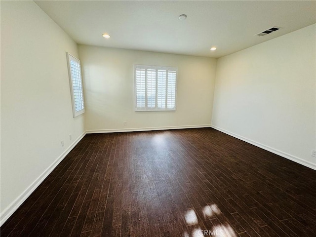 empty room featuring dark hardwood / wood-style flooring