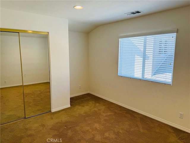 unfurnished bedroom with carpet floors and a closet