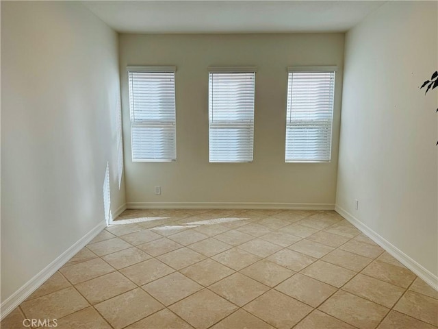 tiled empty room featuring a wealth of natural light