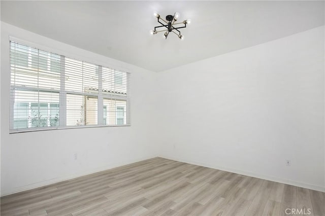 spare room with light hardwood / wood-style floors