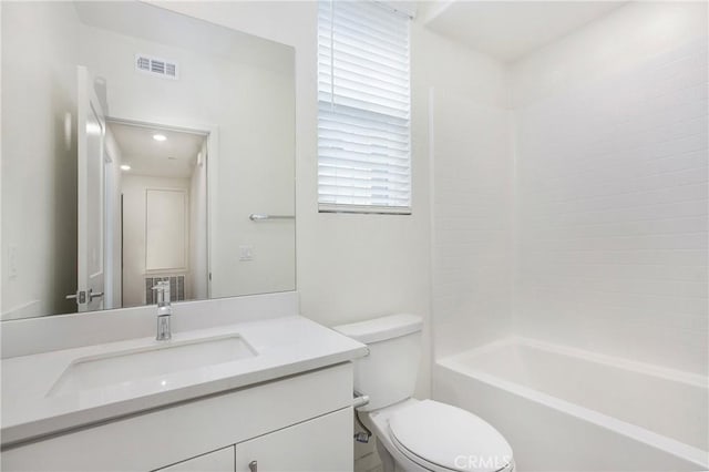 full bathroom featuring vanity, toilet, and shower / bath combination