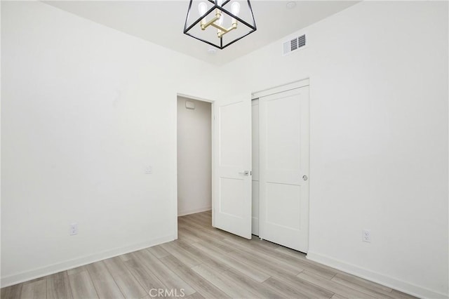 unfurnished bedroom featuring light wood-type flooring and a closet