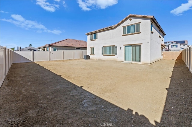 back of property featuring central air condition unit, a fenced backyard, and stucco siding